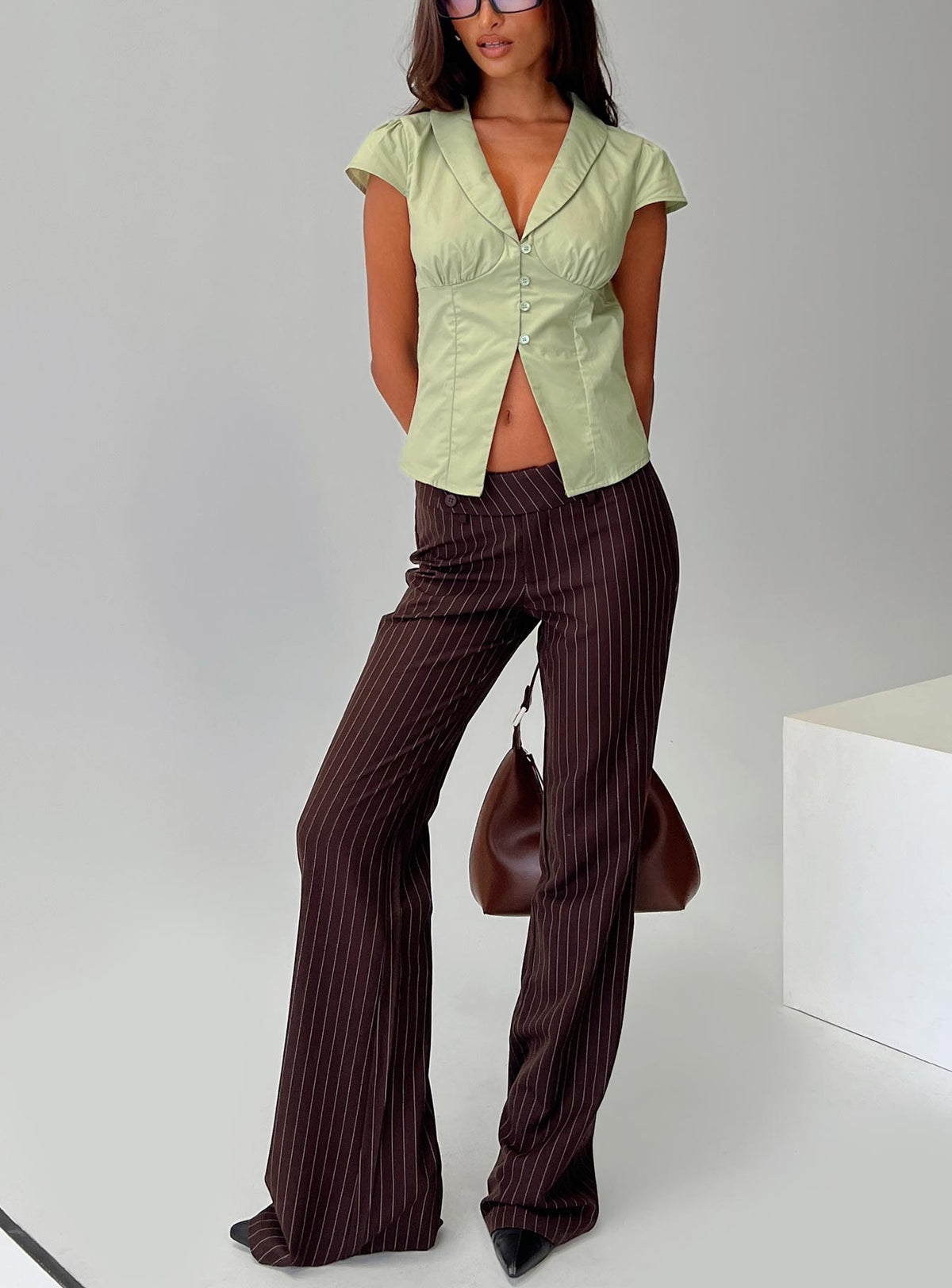 front view of model wearing Princess Polly Kinkirk Flared Pants Brown Pinstripe Low Rise Pants Pants 