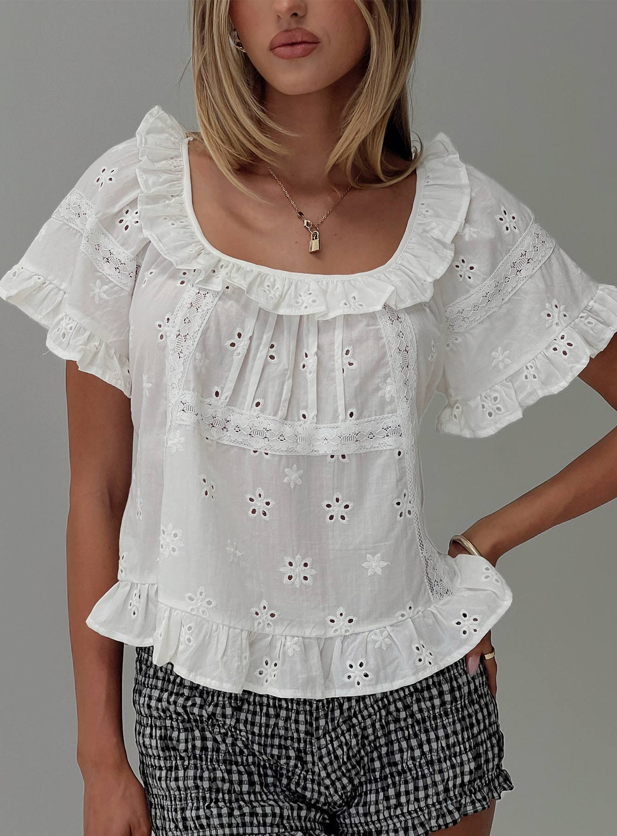 side view of model wearing Princess Polly Teigen Broiderie Top White Short Sleeves Square Neck 
