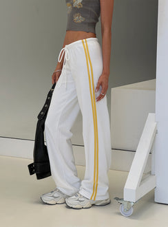 side view of model wearing Princess Polly Elation Low Rise Straight Leg Track Pant White Low Rise Pants Pants 