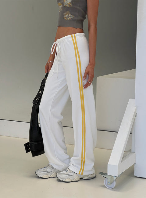 side view of model wearing Princess Polly Elation Low Rise Straight Leg Track Pant White Low Rise Pants Pants 