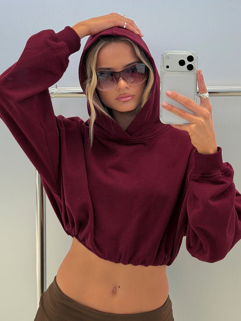 Discover the Mayse Bubble Hem Cropped Hoodie Cherry womens-jumpers in short length front view of model wearing Princess Polly