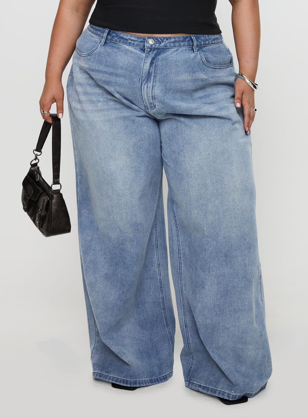 back view of model wearing Princess Polly Naylor Mid Rise Wide Leg Jeans Light Wash Denim Curve Mid Rise Jeans Jeans 