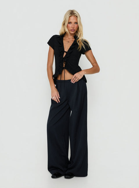 Featuring Yuzima Micro Belt Pleated Pants Navy Pinstripe in womens regular pants with mid-rise detail view of model wearing Princess Polly