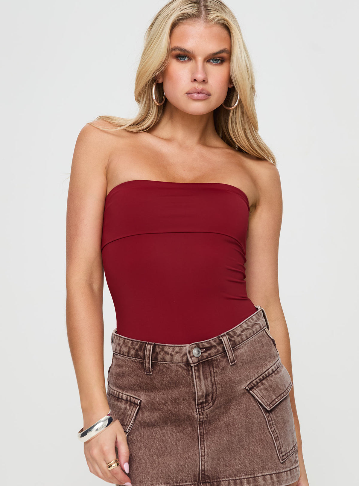 front view of model wearing Princess Polly Niner Strapless Bodysuit Burgundy Petite Sleeveless Bodysuit 