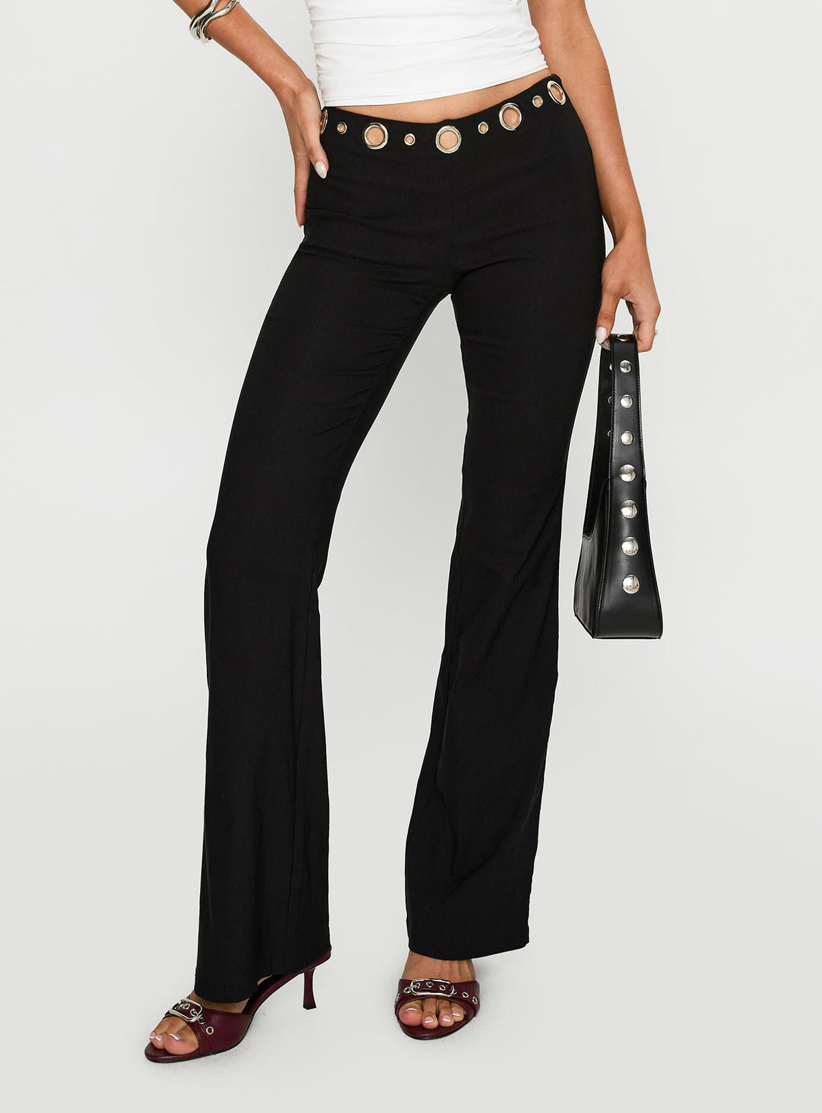 front view of model wearing Princess Polly True Grit Eyelet Flare Pants Black Low Rise Pants 