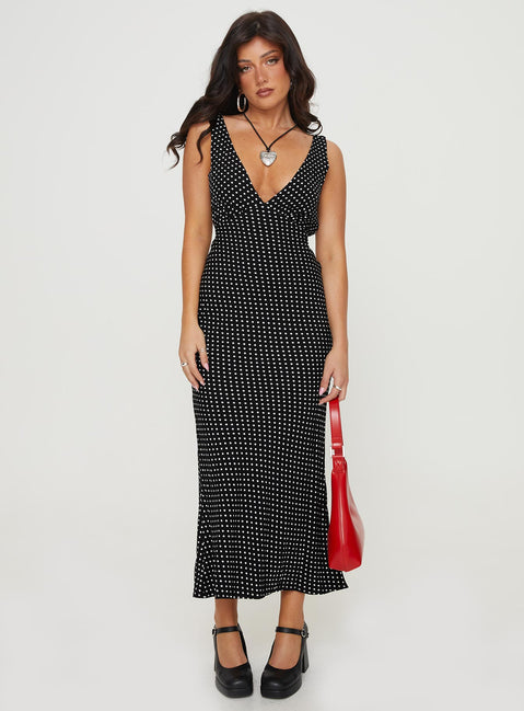 Front view of model wearing  front Princess Polly V-Neck  Nellie Maxi Dress Black Polka Dot Petite