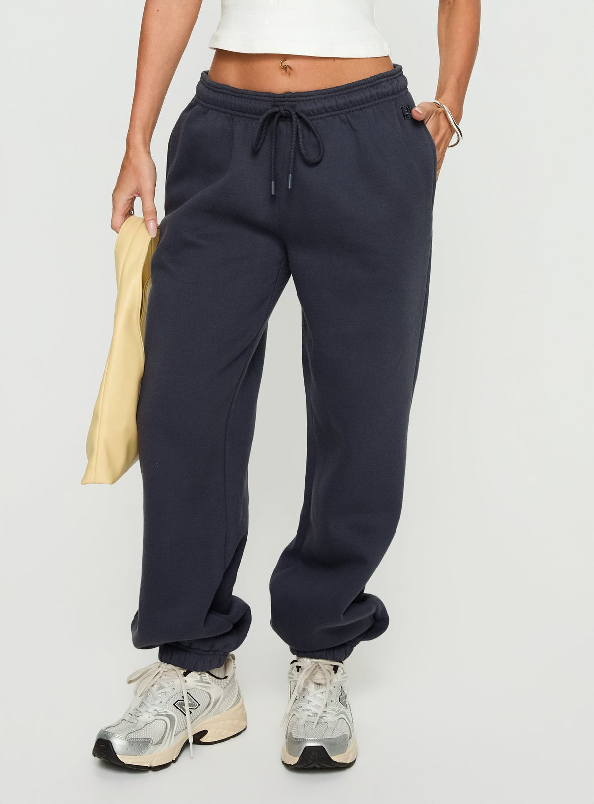 side view of model wearing Princess Polly Caspa Dream Fleece Oversized Ankle Cuff Jogger Navy High Rise Pants Pants 