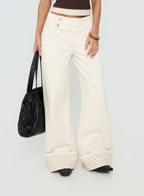 Featuring the Nikoletta Foldover Jeans Cream / Polka Petite womens-jeans in high-rise front view of model wearing Princess Polly