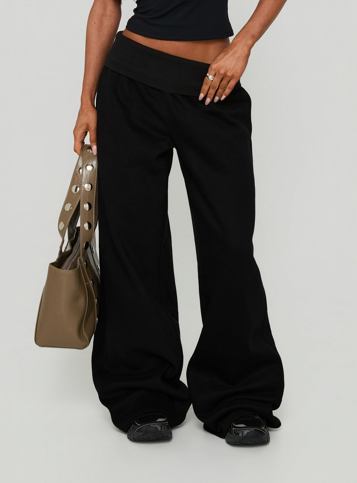 Showcasing the Lockie Foldover Baggy Track Pants Black womens-regular-pants with high-rise detail view of model wearing