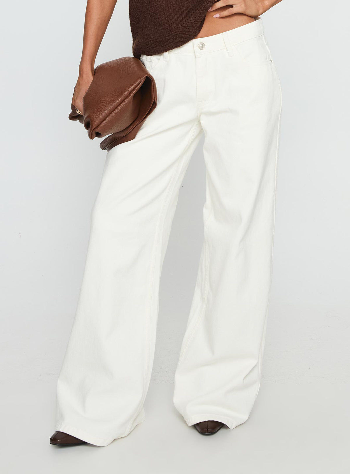 back view of model wearing Princess Polly Ramos Low Rise Wide Leg Jeans White Low Rise Jeans 