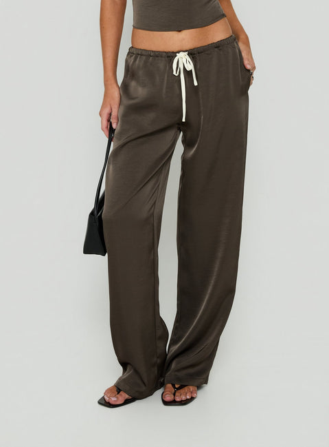 Featuring the Dialled Up Tie Waist Satin Pants Mocha in womens regular wide-leg silhouette with mid-rise belt side view of model wearing Princess Polly