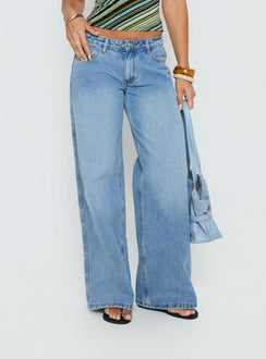 Featuring the Ramos Low Rise Denim Jeans Bright Blue Wash Tall in womens-jeans with low-rise waist detail view of model wearing