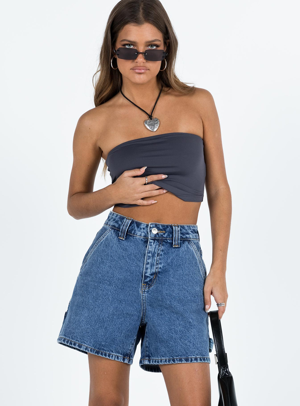 front view of model wearing Princess Polly Lou Carpenter Denim Shorts Mid Wash Petite High Waisted Shorts 