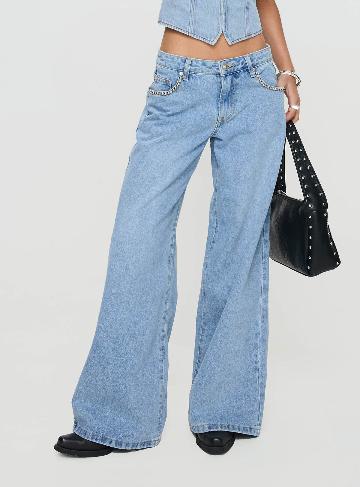 side view of model wearing Princess Polly Pearlisle Low Rise Baggy Jeans Light Wash Low Rise Jeans Jeans 