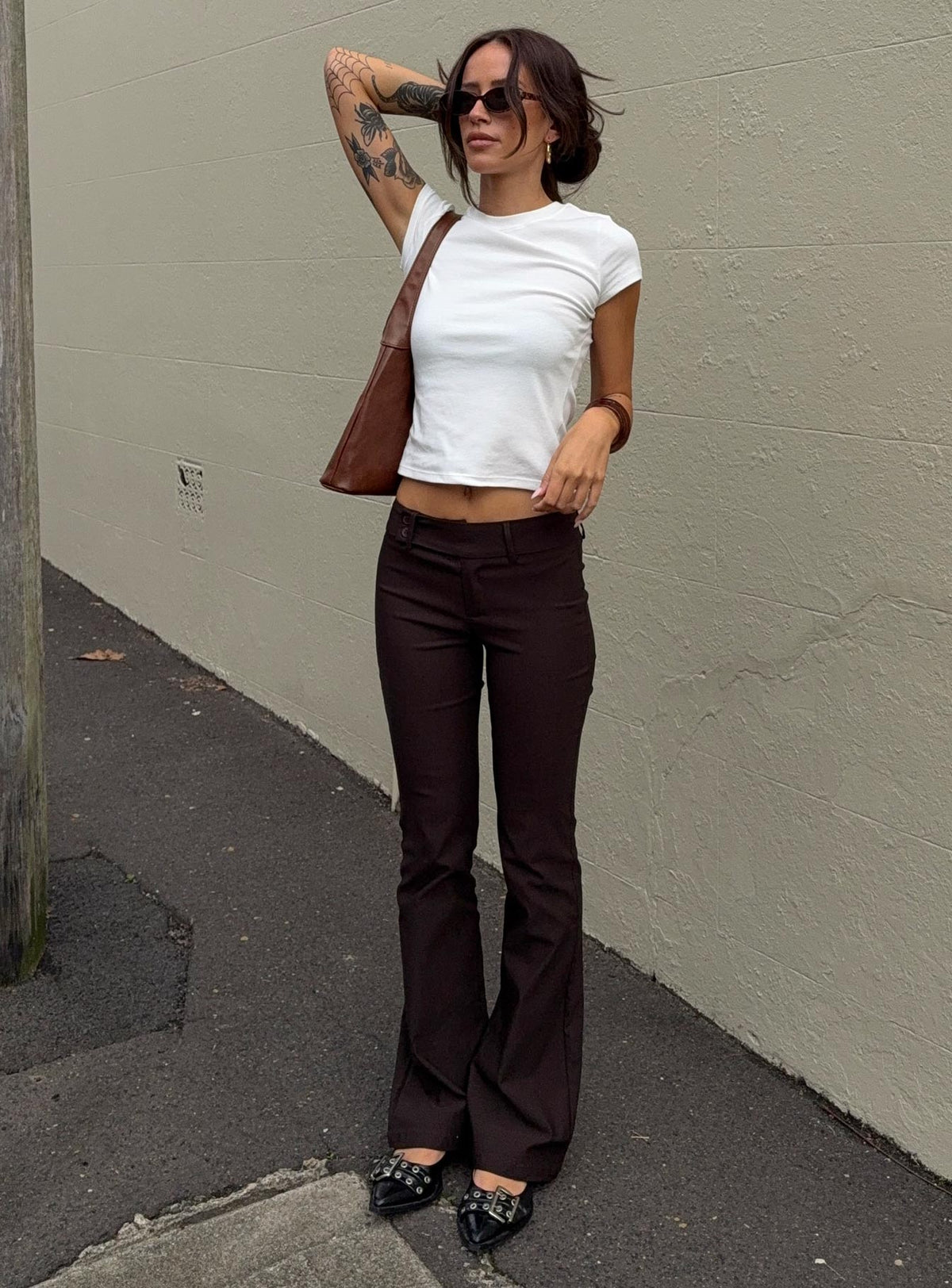 front view of model wearing Princess Polly Kinkirk Flared Pants Chocolate Tall Low Rise Pants Pants 