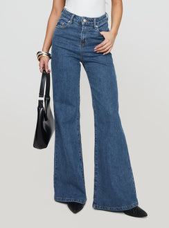 front view of model wearing Princess Polly Lucille High Rise Flared Jeans Mid Wash High Rise Jeans Jeans 