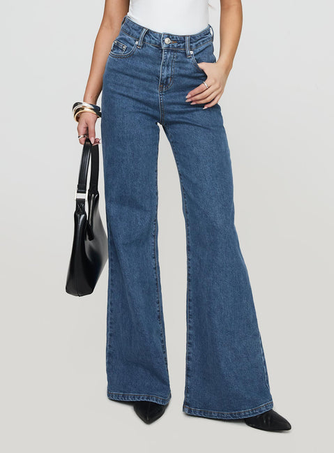 front view of model wearing Princess Polly Lucille High Rise Flared Jeans Mid Wash High Rise Jeans Jeans 