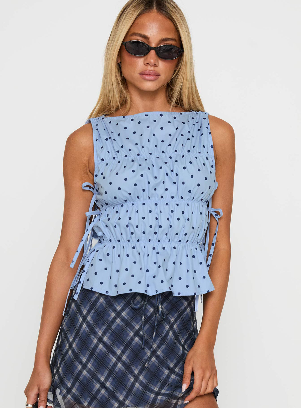 front view of model wearing Princess Polly Endless Summers Tie Side Top Blue Polka Dot Sleeveless Boat Neck 