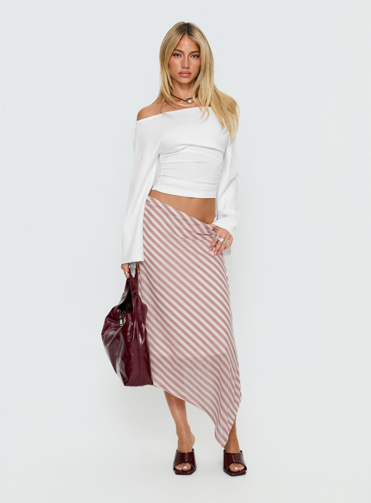   side view of model wearing Princess Polly Gwenora Asymmetrical Midi Skirt Pink Stripe Midi Skirts Skirts 