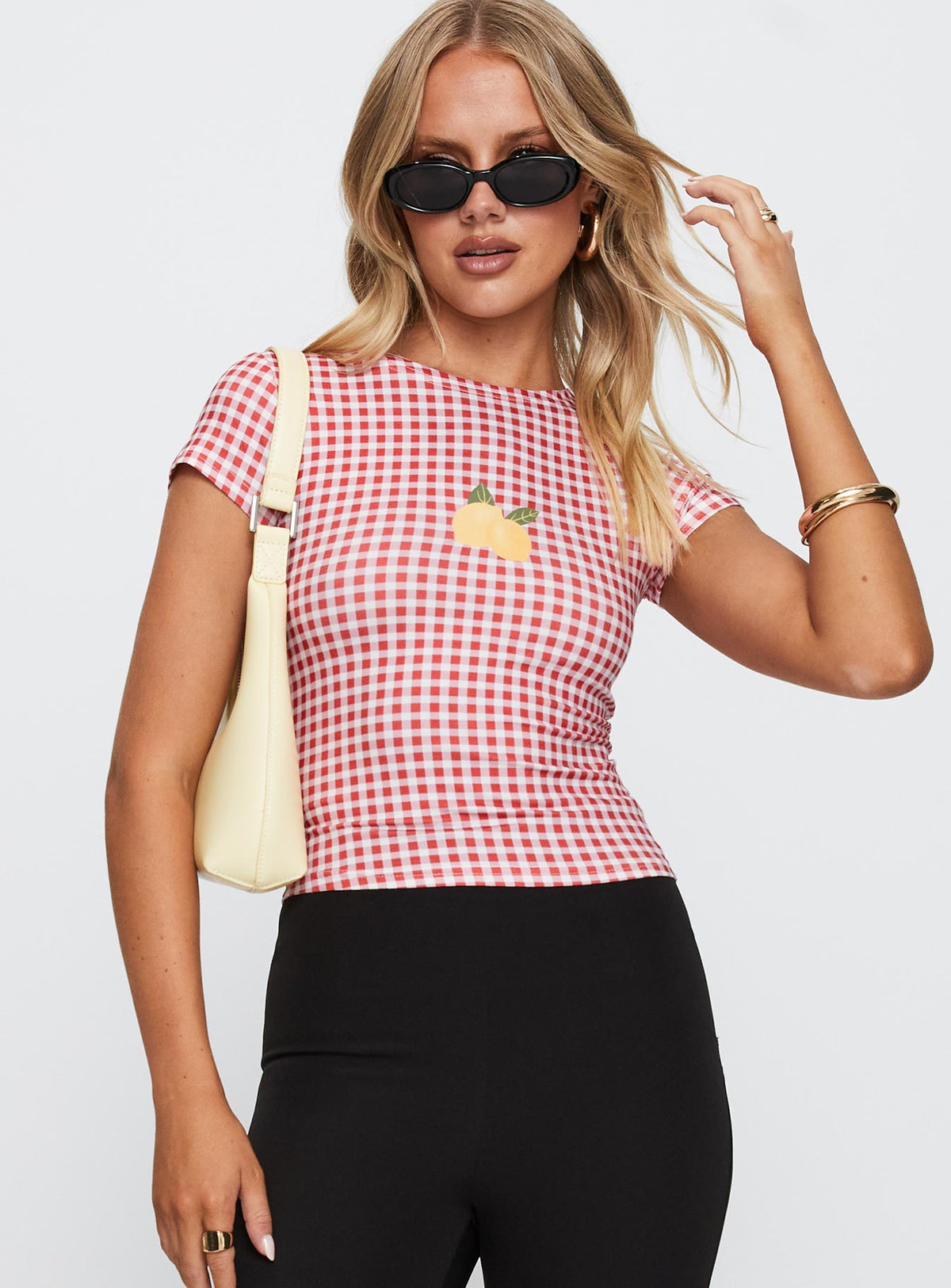 front view of model wearing Princess Polly Marcello Graphic Top Red Check Sleeveless Crew Neck 