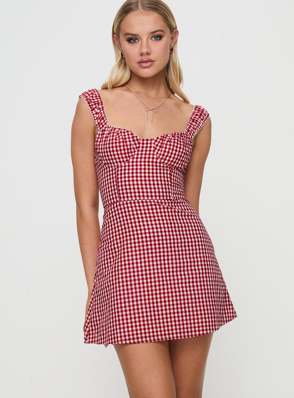 front view of model wearing Princess Polly Faubert Mini Dress Red Gingham Petite Sweetheart Neckline 