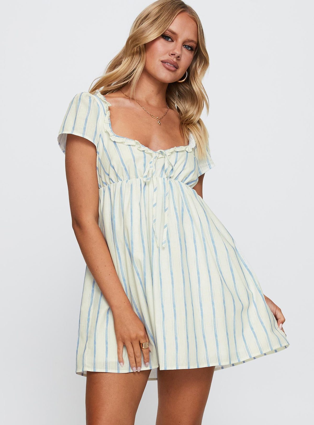 side view of model wearing Princess Polly Monsterrat Mini Dress Blue Stripe Sweetheart Neckline 