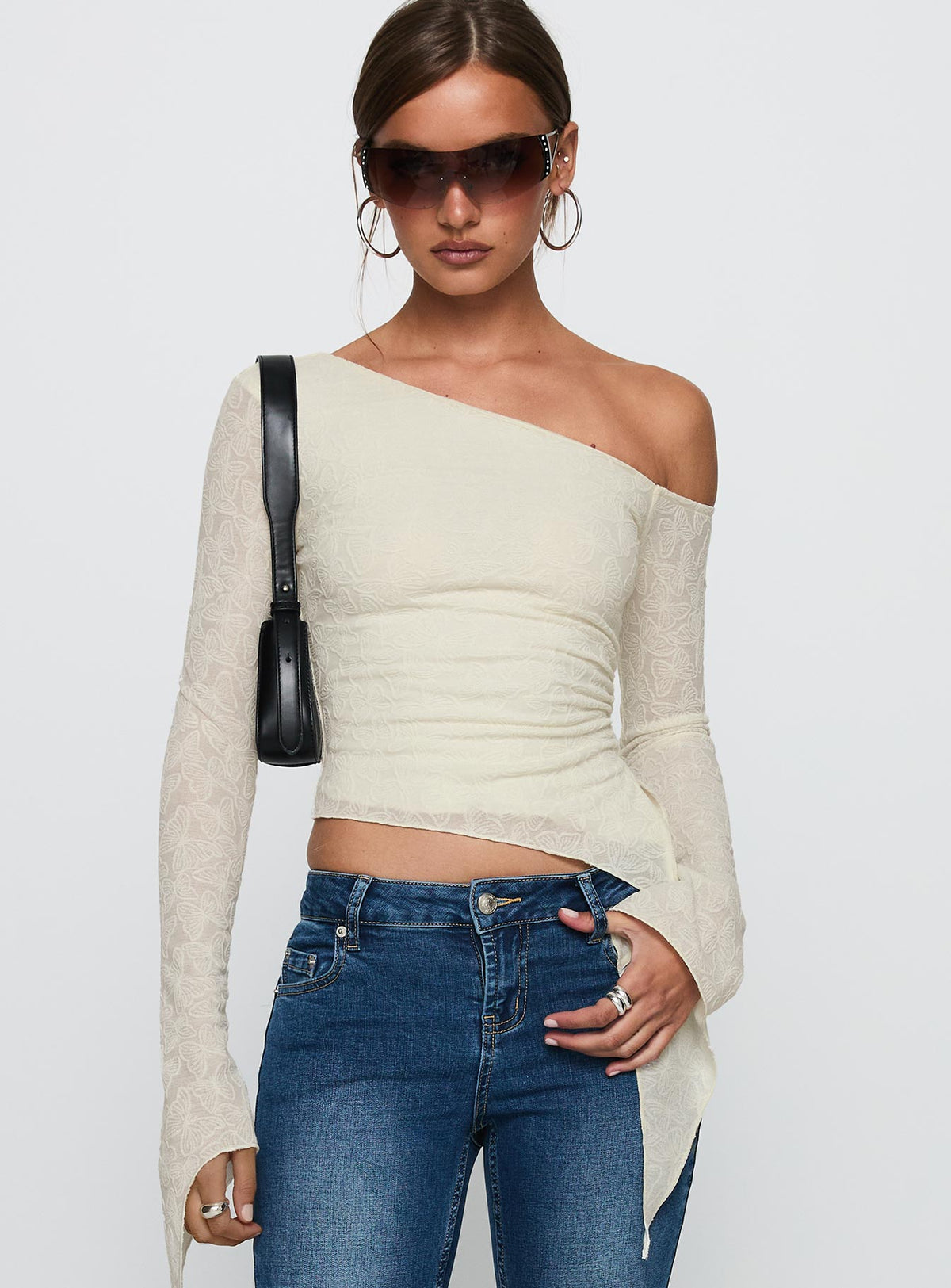 front view of model wearing Princess Polly Face Card Long Sleeve Top Cream Full Sleeves Asymmetric Neckline 