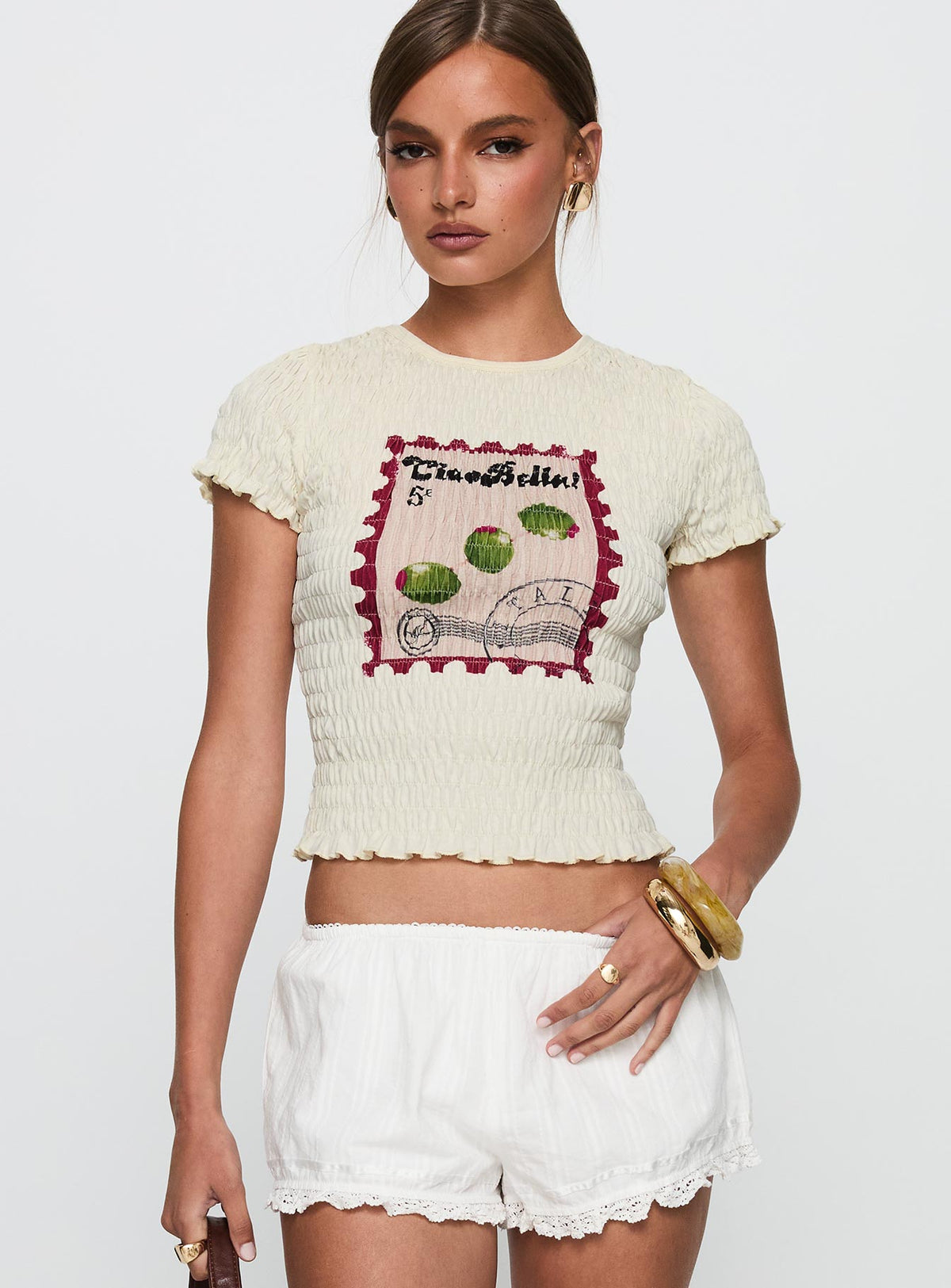 front view of model wearing Princess Polly Ciao Bella Shirred Graphic Top Cream Short Sleeves Crew Neck 