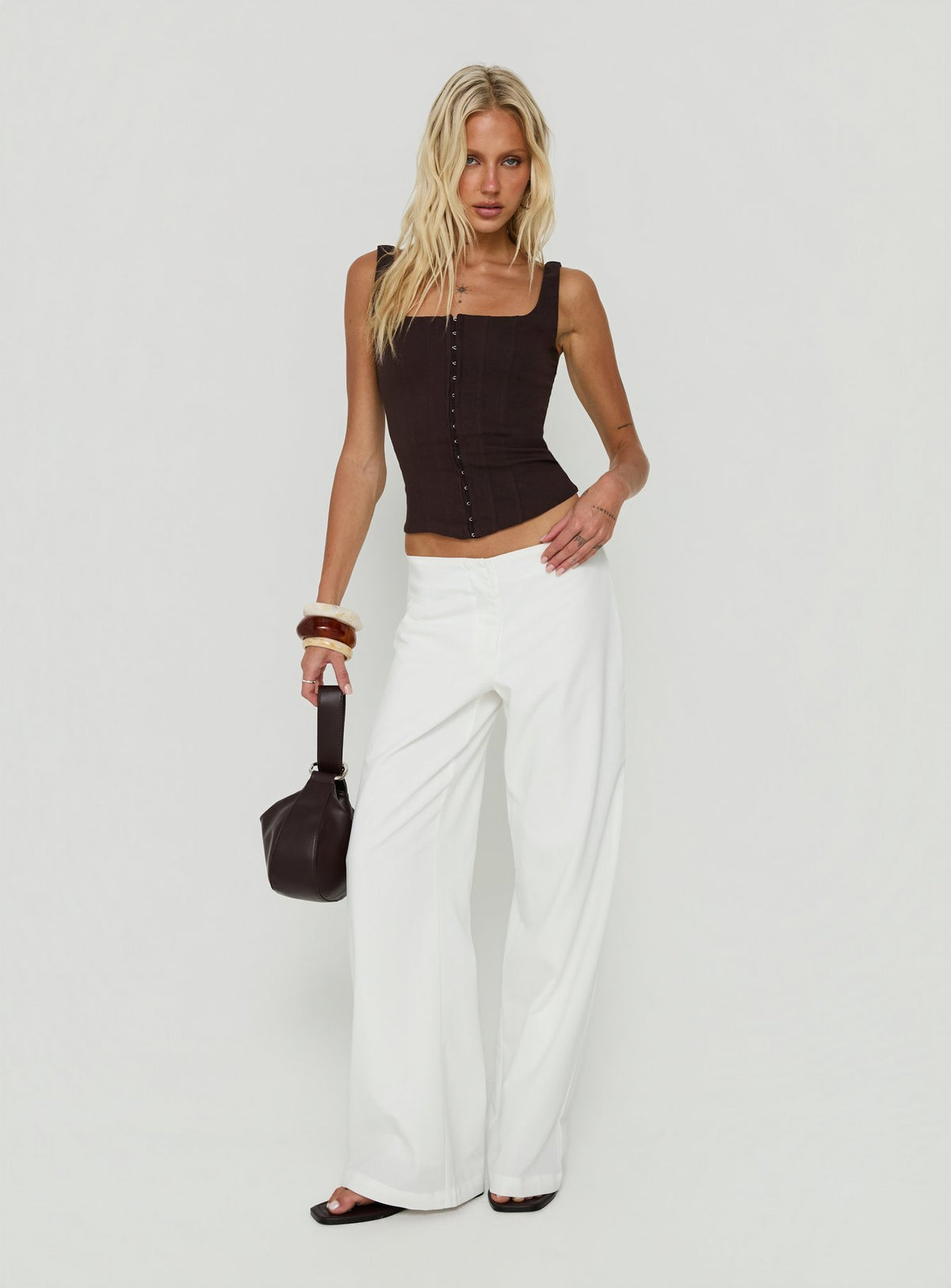 Featuring the Agazia No Waist Low Rise Straight Pants White in womens regular pants with low-rise front view of model wearing