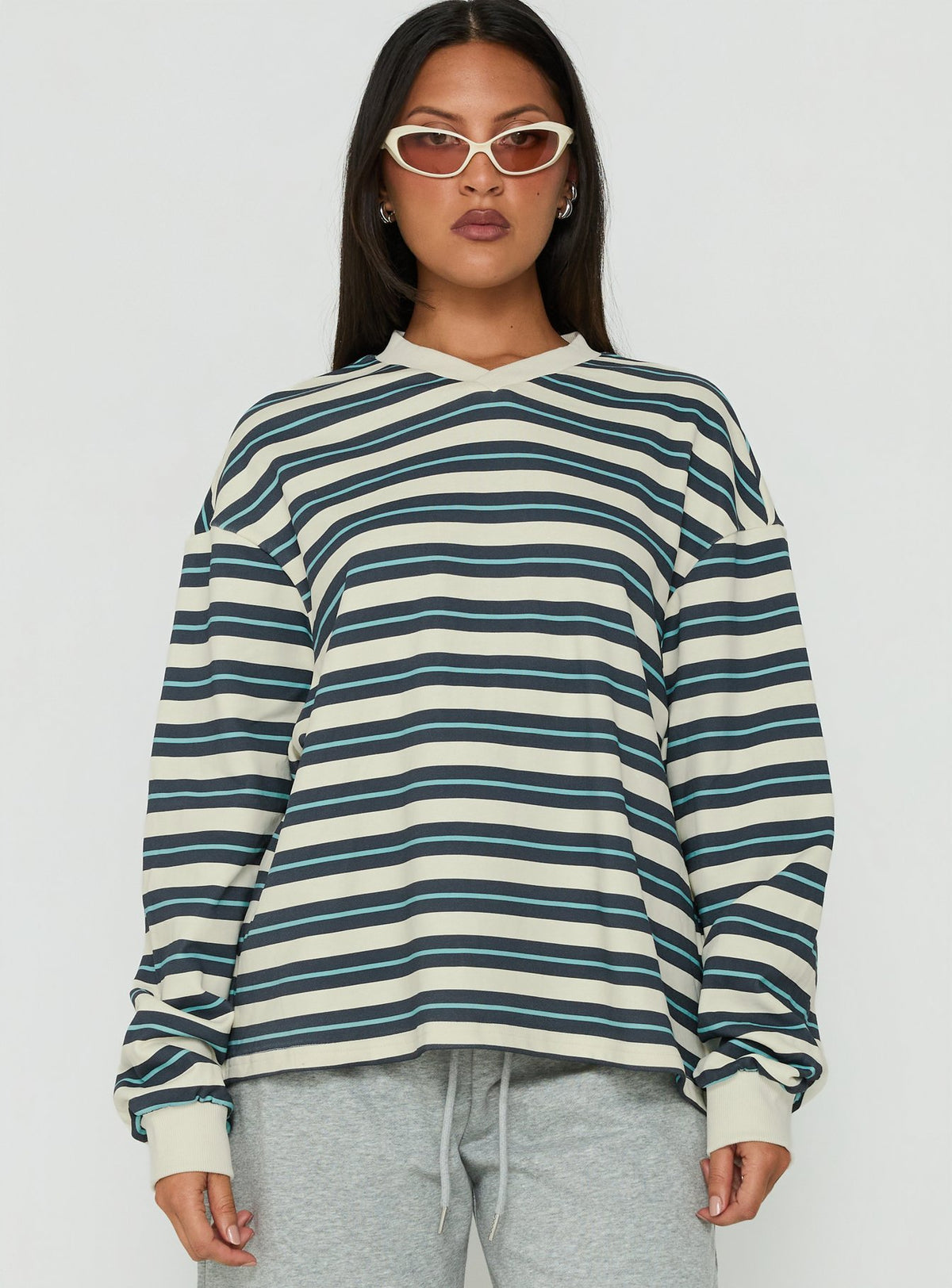 Showcasing the Opollo V Neck Jumper Blue Multi Stripe womens-jumpers with short length front view of model wearing Princess Polly