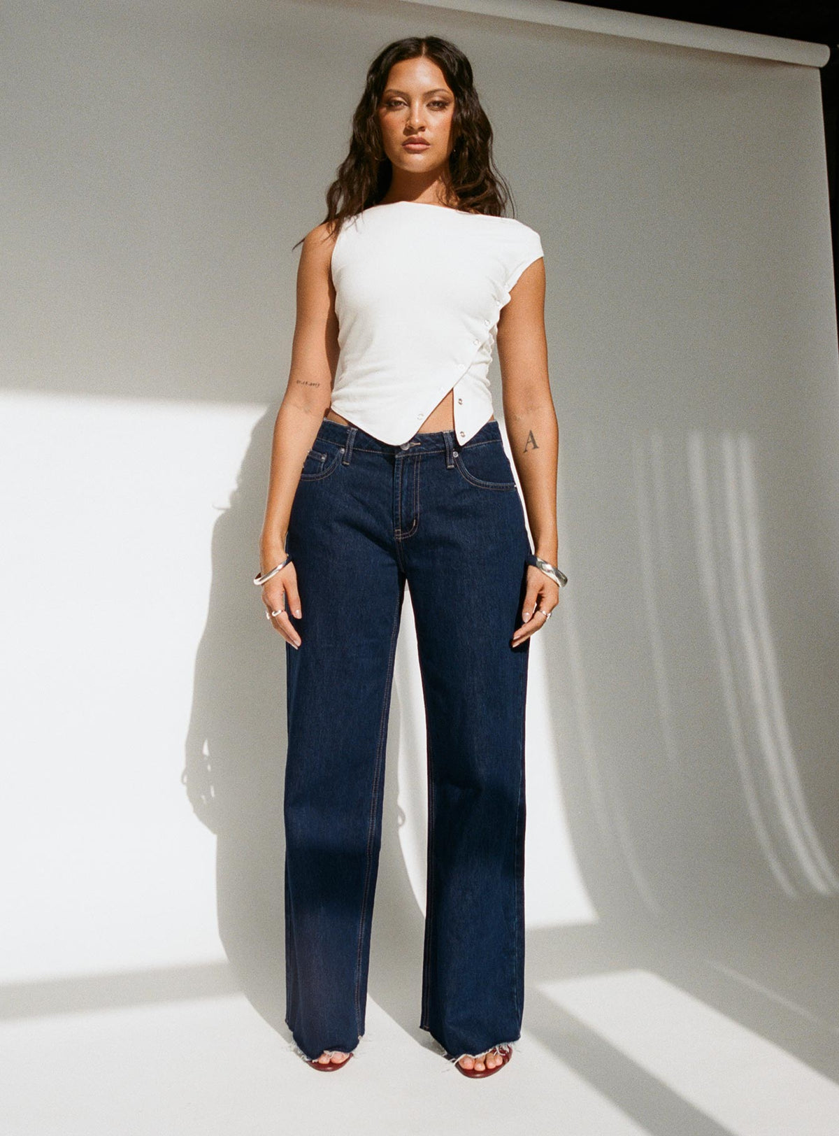 front view of model wearing Princess Polly Darla Low Rise Straight Jean Dark Wash Petite Low Rise Jeans 