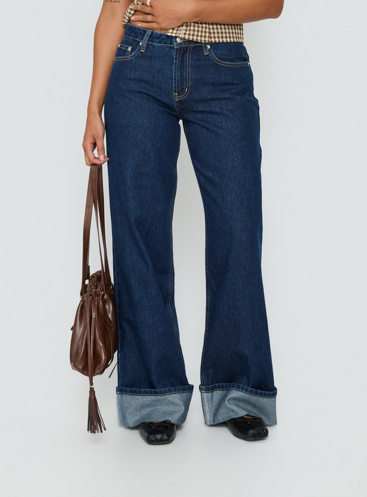 side view of model wearing Princess Polly Darla Low Rise Straight Leg Cuff Jean Dark Blue Wash Low Rise Jeans Jeans 