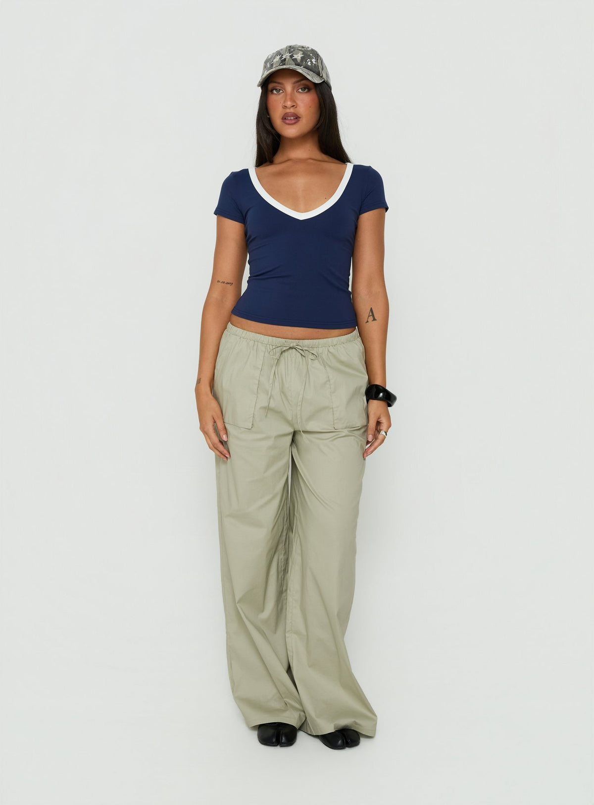 Showcasing the Toren Drawstring Straight Leg Pants Stone womens-regular-pants with mid-rise front view of model wearing Princess Polly