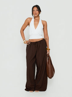 Featuring the Bungala Oversized Relaxed Pants Brown Pinstripe womens-regular-pants with mid-rise front view of model wearing Princess Polly