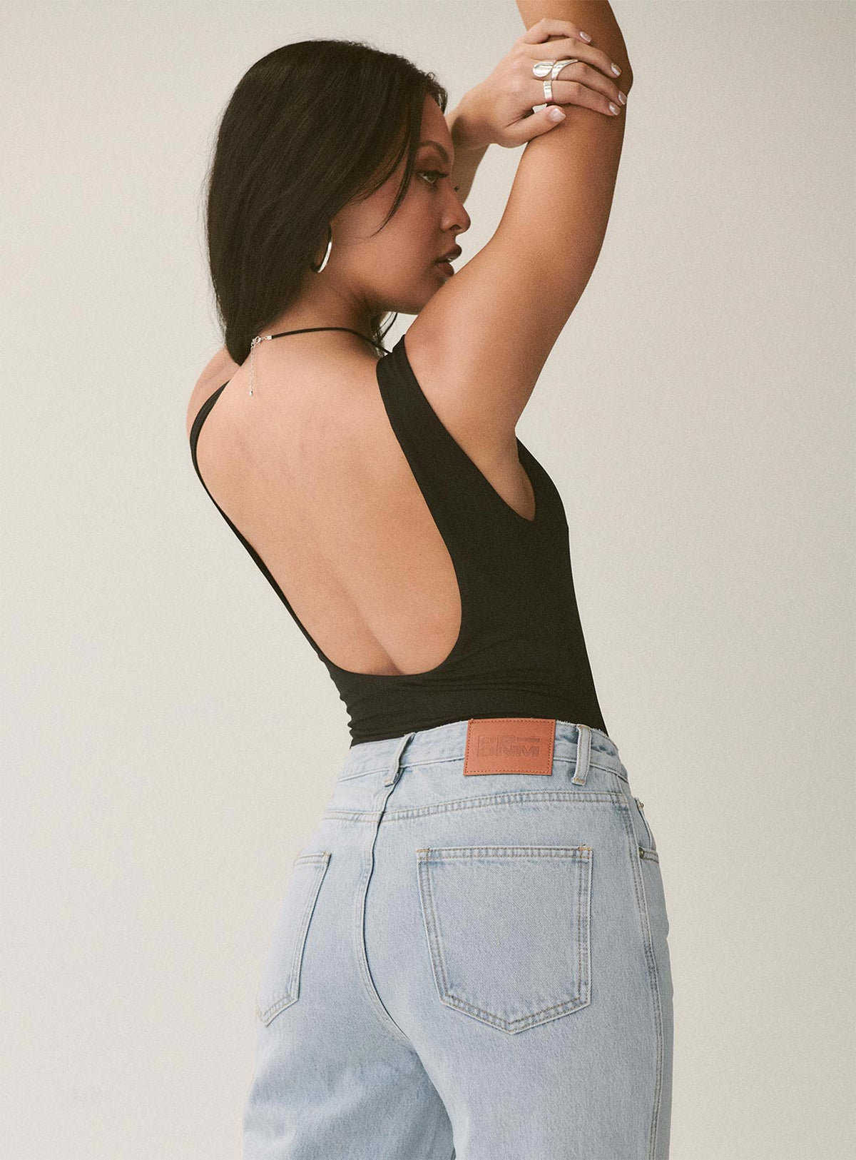 side view of model wearing Princess Polly Beresford Bodysuit Black Sleeveless Bodysuit 