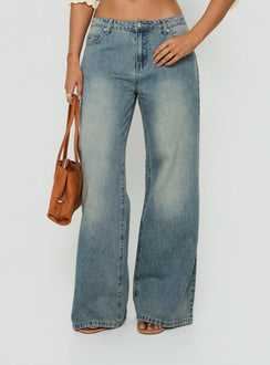 Discover the Karlos Low Rise Cinched Baggy Jeans Vintage Mid Blue Wash in womens-jeans featuring abstract print front view of model wearing Princess Polly