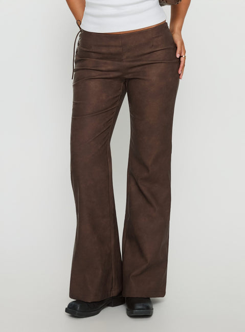 side view of model wearing Princess Polly Trickrider Tie Side Faux Leather Pants Chocolate Mid Rise Pants Pants 