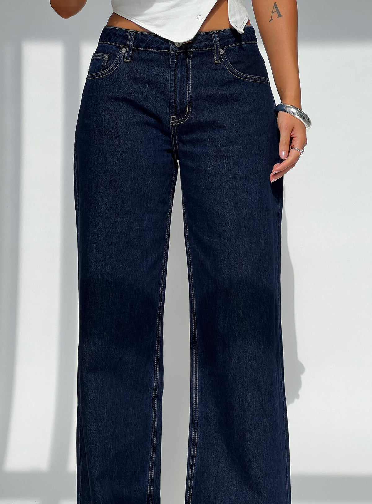 back view of model wearing Princess Polly Darla Low Rise Straight Jean Dark Wash Petite Low Rise Jeans 
