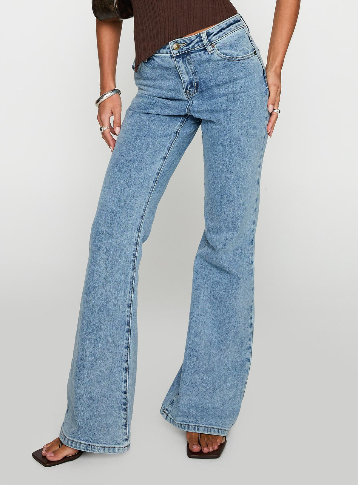 back view of model wearing Princess Polly Magic Mirror Mid Rise Bootleg Jeans Ice Wash Petite Mid Rise Jeans 
