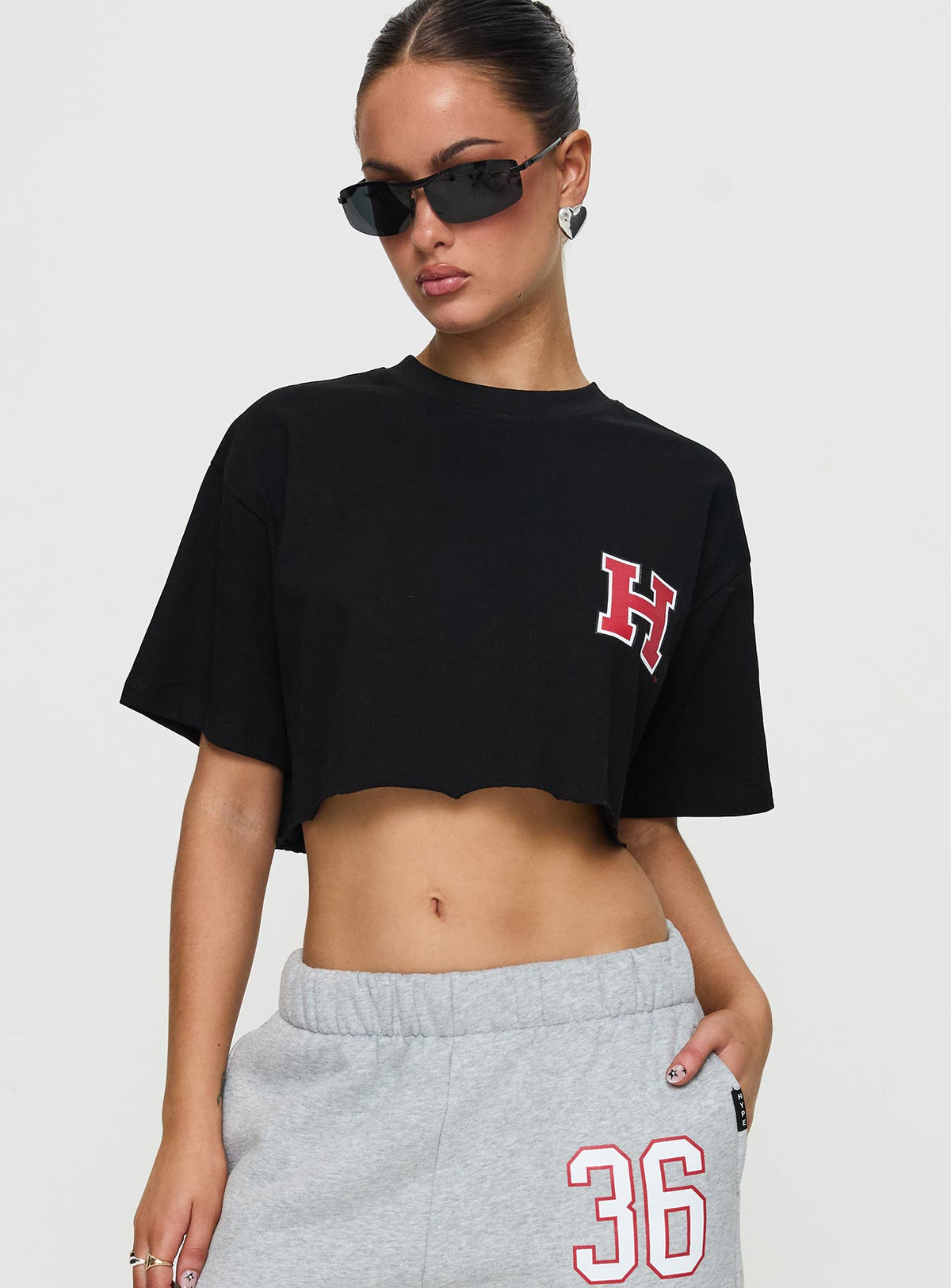 side view of model wearing Princess Polly Harvard Graphic Track Top Black Short Sleeves Crew Neck 