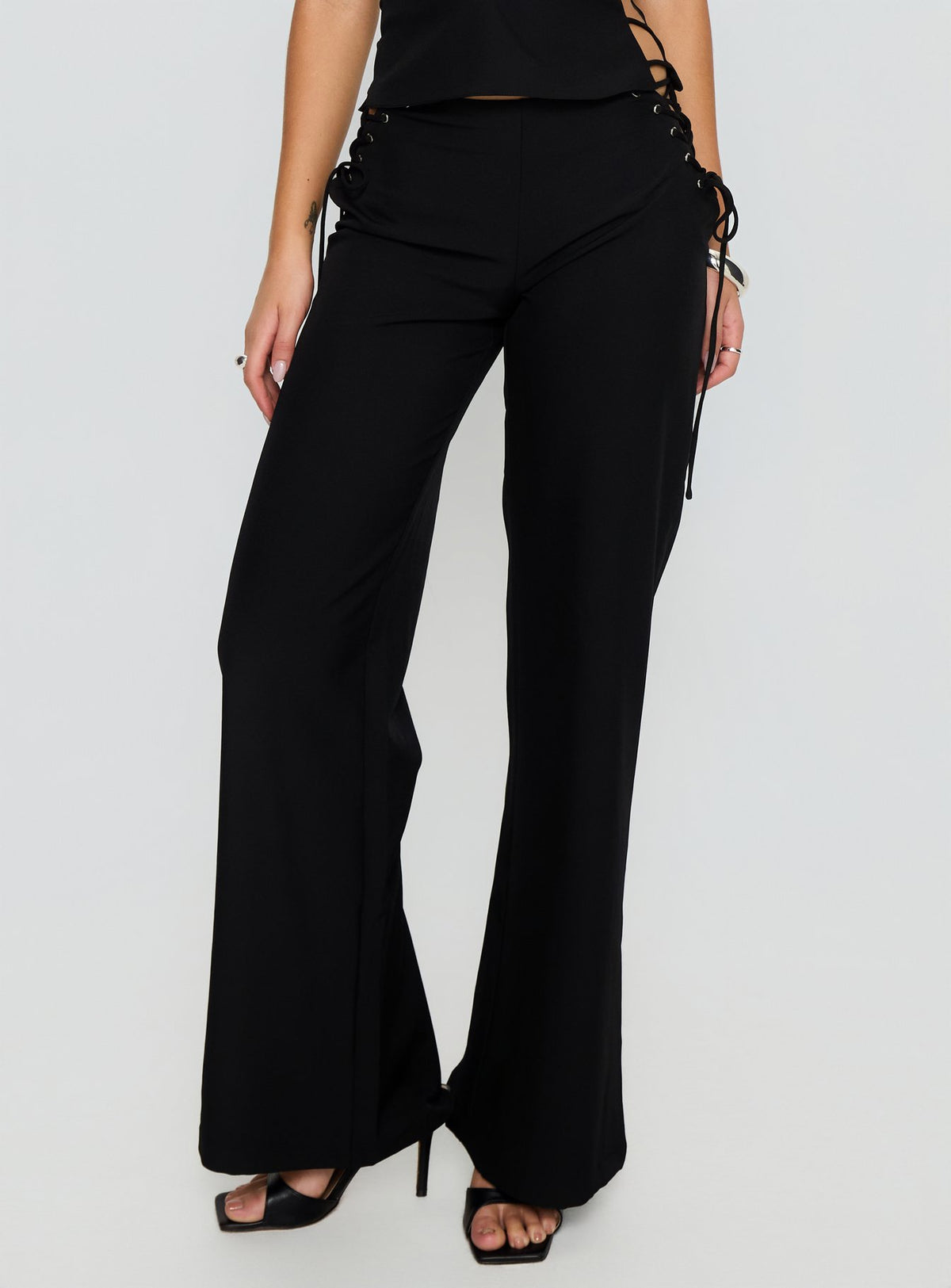 back view of model wearing Princess Polly Riane Lace Up Pants Black Mid Rise Pants Pants 