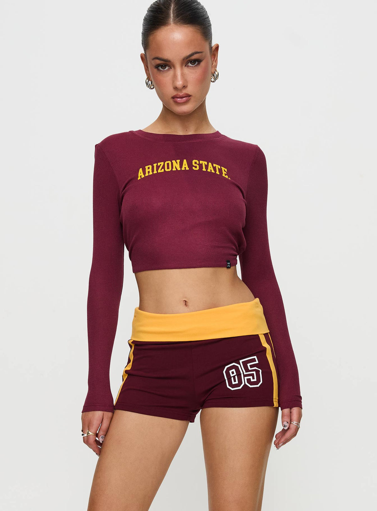 front view of model wearing Princess Polly ASU Foldover Shorts Maroon Low Rise Shorts 