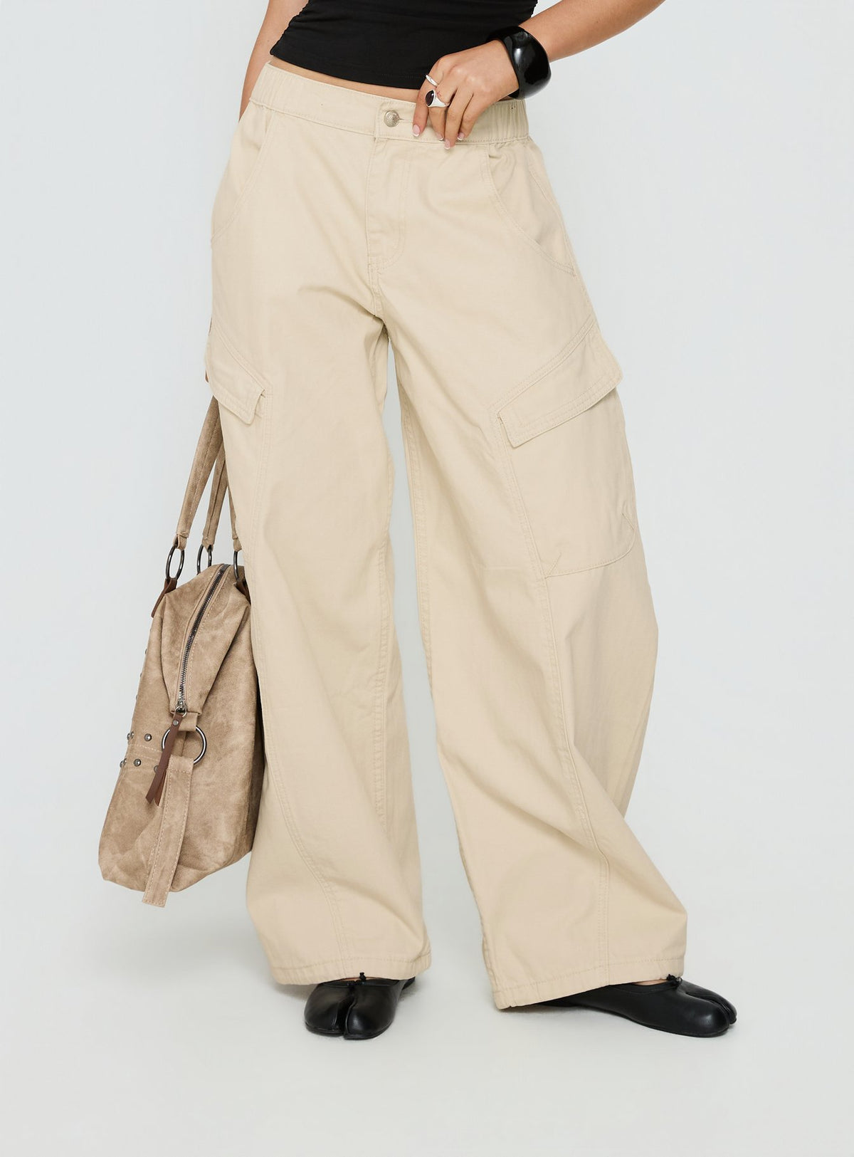 side view of model wearing Princess Polly Selective Memory Low Rise Wide Leg Cargo Pants Cream Low Rise Pants Pants 
