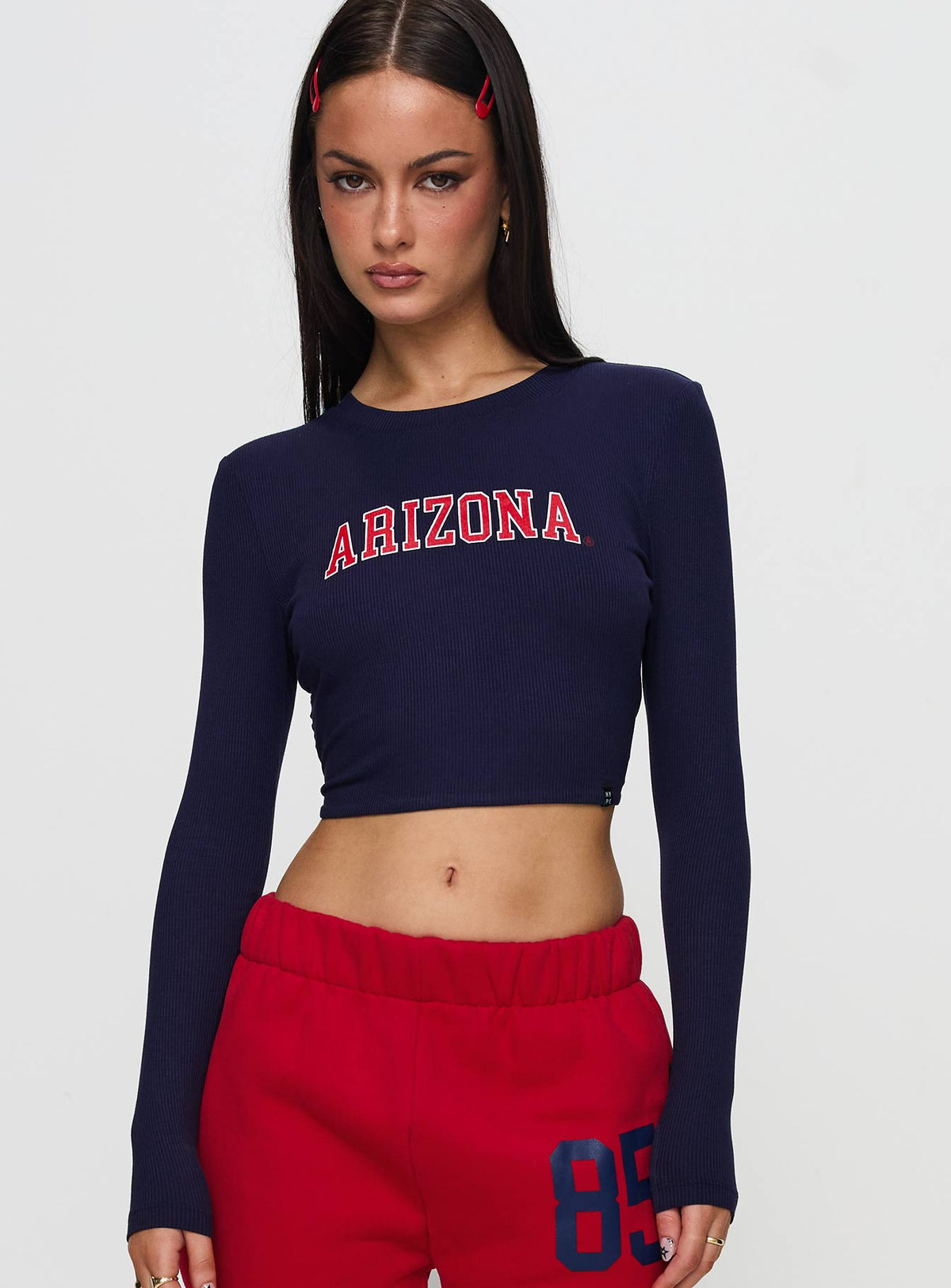 front view of model wearing Princess Polly U of A Bring It Back Long Sleeve Top Navy Full Sleeves Crew Neck 