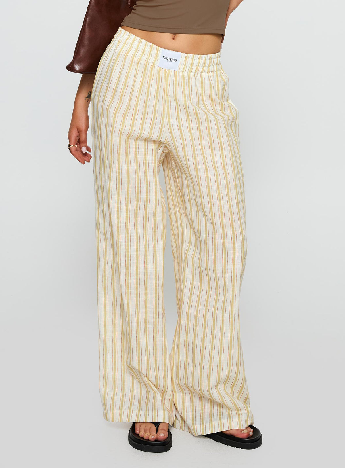 side view of model wearing Princess Polly Beach House Pants Yellow Stripe High Rise Pants Pants 
