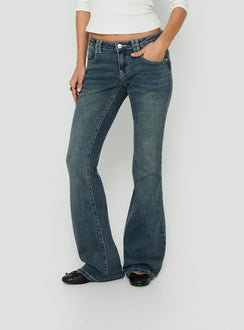 Crafted from low-rise denim, the Clynee Ultra Low Rise Bootleg Jeans Dirty Blue in womens-jeans front view of model wearing Princess Polly