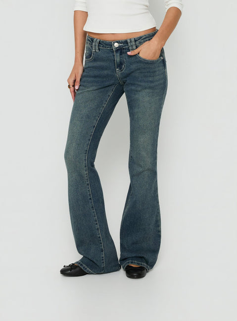 Crafted from low-rise denim, the Clynee Ultra Low Rise Bootleg Jeans Dirty Blue in womens-jeans front view of model wearing Princess Polly
