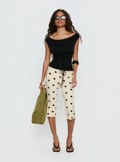 side view of model wearing Princess Polly Samaira Capri Pant Cream Polka Dot Mid Rise Pants Pants 