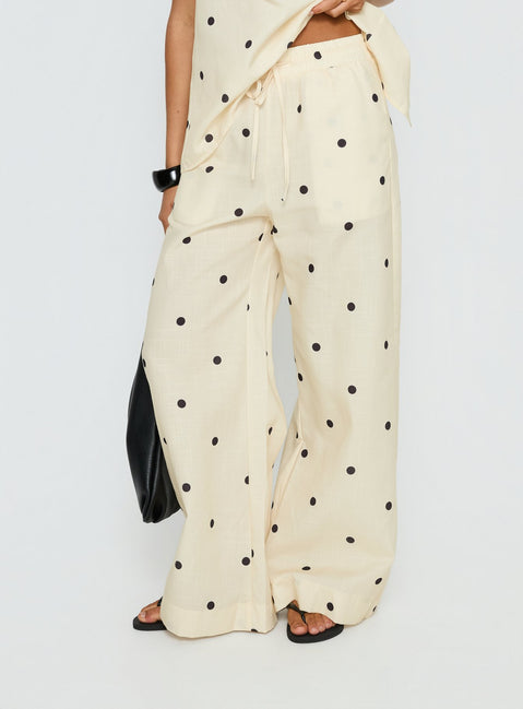 Crafted from cornsilk fabric, Bellara Tie Waist Pants Yellow Polka womens regular pants feature mid-rise and belt detail view of model wearing Princess Polly