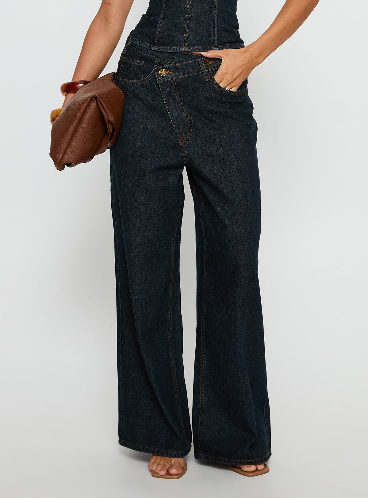 side view of model wearing Princess Polly Blue Crush Low Rise Wide Leg Jeans Indigo Mid Rise Jeans Jeans 